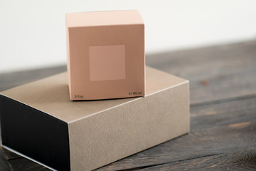 Two gift boxes, blush coral color and craft paper. Stylish minimalist brand packaging concept.