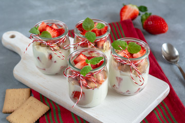 Yogurt with fresh strawberries and crumbled biscuits. Healthy breakfast.