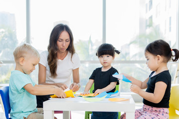 Teacher and students making origami crafts