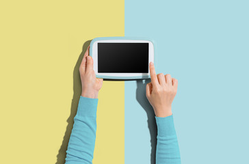 Person using a tablet computer from above