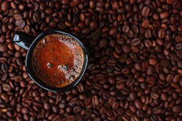 Delicious fresh coffee in a black mug