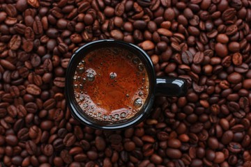 Delicious fresh coffee in a black mug