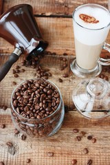 Roasted coffee beans and a cinnamon Dolce latte