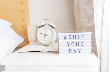 Inspiration Motivational Life Quotes hashtag Rule your day message on lightened box with alarm...