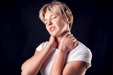 Fototapeta na wymiar Woman feels neck pain. People, healthcare and medicine concept