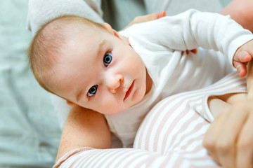 Young woman breast feeding her newborn child baby. Mother's milk is the best food for the baby. An...