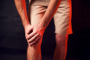 Man feels strong knee pain. People, healthcare and medicine concept