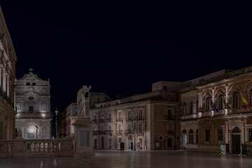 Fototapeta na wymiar Nightscape of the central street of the Ortigia island at night, province of Siracusa, Sicily, south Italy