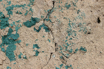 Texture of old cracked stone wall with paint splatter