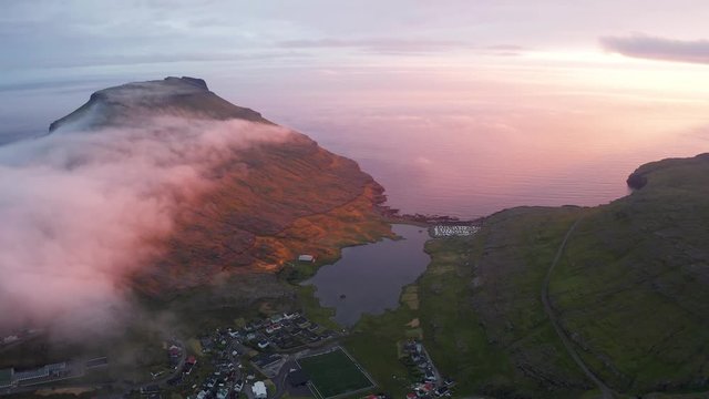 Aerial drone video flying over Eidi village, located on the north-west tip of Eysturoy island, Faroe Islands, Denmark. UHD 4k video