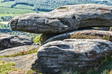 Fototapeta na wymiar Curbar Gap and Frogatt Edge Hope Valley, Derbyshire Peak District - outdoors for rambling, hiking, and walking. Carboniferous stone boulders, heather and grit rock formations. 