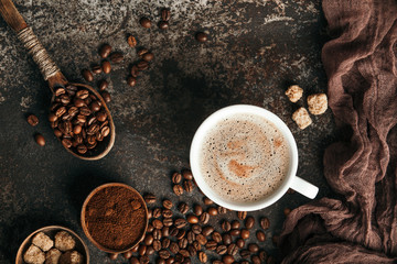 Coffee board with coffee beans on dark textured background.
