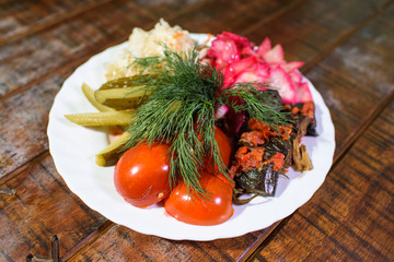 Salted and pickled vegetables on a wooden beautiful table