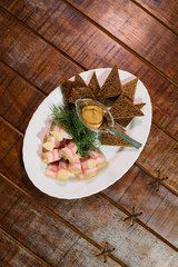 Dish of lard with croutons on a large old wooden table