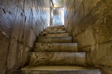 Stone steps. Old staircase leading up towards the light.