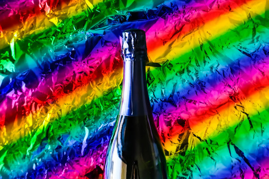Bottle of champagne rainbow background.
