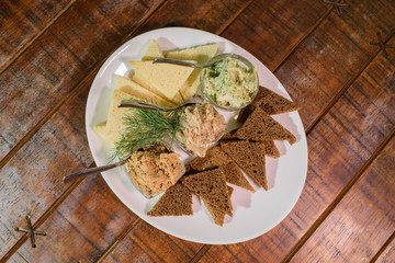 Tasty croutons with formak, liver pate and lard with garlic. Russian appetizer