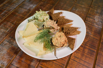 Tasty croutons with formak, liver pate and lard with garlic. Russian appetizer