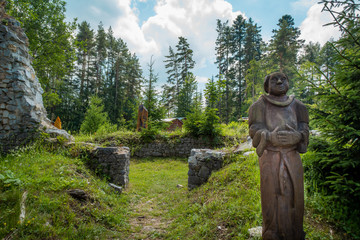 Slovak Paradise, Letanovce / Slovakia - Wooden statue of a monk in the ruins of the Klastorisko monastery in the Slovak Paradise National Park