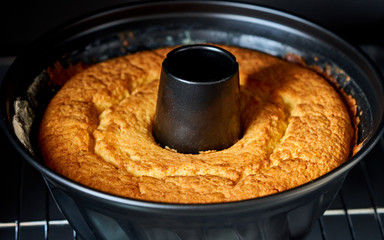 cake is baked in a round form in the oven