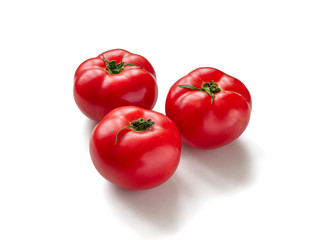 Three red, ripe tomatoes on a white background