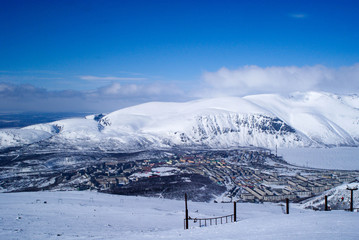 Fototapeta na wymiar Kirovsk, Murmansk region winter - mountain range and town and lake