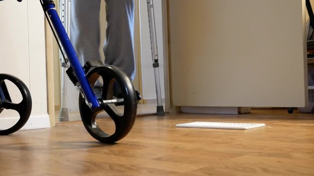 Person Using Crutches Walks Toward Camera From Out of Sigh