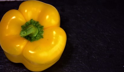 fresh yellow paprika on a black background