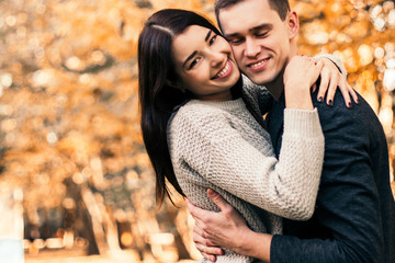 Fototapeta premium Beautiful young couple walking in autumn park.
