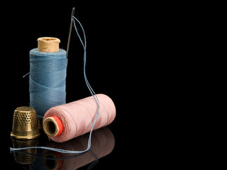 Sewing threads of blue and pink colors