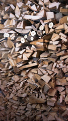  Detail of logs stacked for firewood. Background of dry chopped firewood logs in a pile. Harvesting firewood for the winter.