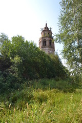 Naklejka premium the abandoned bell tower of the Rubezhy church in Usolye among the trees