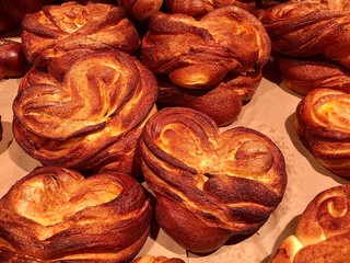 Background texture: pastry. Tasty croissant on a store shelf. Donuts with sweet filling. Baked sweet buns.