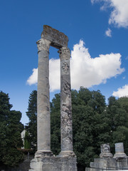 Two stone columns under a blue sky in the roman theatre in arles