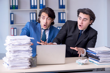 Two male colleagues unhappy with excessive work