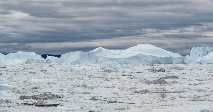 Iceberg aerial drone image - giant icebergs in Disko Bay on greenland floating in Ilulissat icefjord from melting glacier Sermeq Kujalleq Glacier, Jakobhavns Glacier. Global warming, climate change