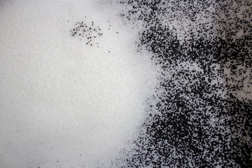 surface made of white plastic granules with black granules mixed with them.