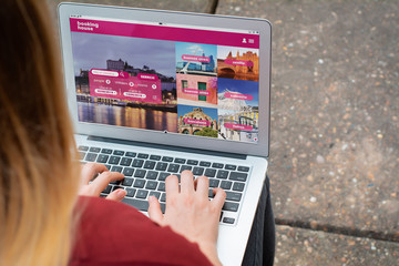 Woman with laptop booking a hotel on website
