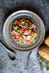 Vegan chickpea salad with roasted mushrooms, cherry tomatoes and onion