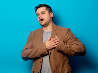 Man with ill heart on blue background