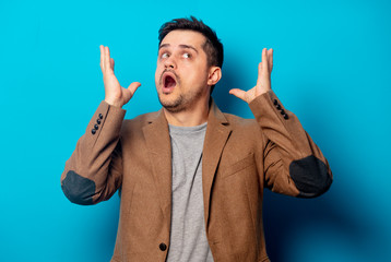 man with headache on blue background