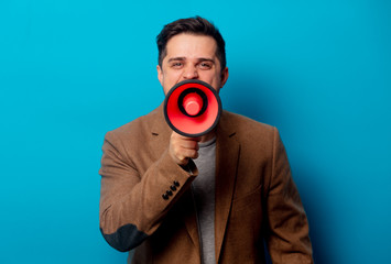 Style man with loud-hailer on blue background