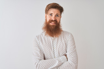 Young redhead irish man wearing shirt standing over isolated white background happy face smiling...