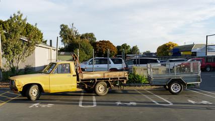 A pick up truck and trailer parked across three push chair and baby parking bays. © Gary