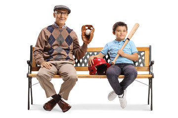 Obraz na płótnie Canvas Boy and an elderly man sitting on a bench with a baseball equipment