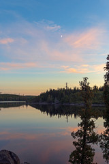 Clouds and Moon on Calm Lake at Dusk