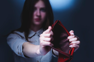 Pain and poverty concept. Stressed and depressed woman screams in despair with empty wallet