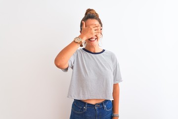 Young redhead modern woman wearing a bun over isolated background smiling and laughing with hand on...