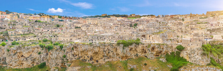 Fototapeta na wymiar Aerial panoramic view of historical centre Sasso Caveoso old ancient town Sassi di Matera with cave rock houses with dramatic sky, view from Murgia Timone, UNESCO Heritage, Basilicata, Southern Italy