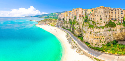 Aerial panoramic view of Tropea town and beach coastline of Tyrrhenian Sea with turquoise azure water, colorful houses buildings on top of high big rocks, road along sea, Calabria, Southern Italy - obrazy, fototapety, plakaty